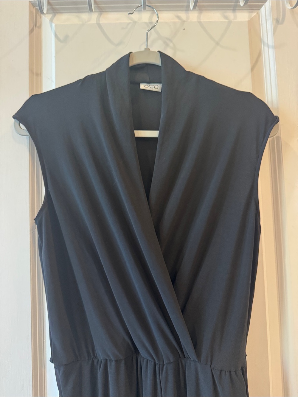Cato sleeveless black jumpsuit featuring a surplice wrap-style front